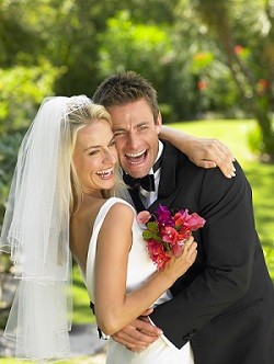 Young married couple in bride and groom outfit.