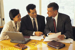 Financial Advisor with Clients reviewing paperwork.