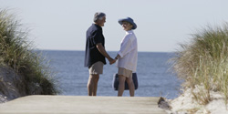 Senior couple holding hands on the beach